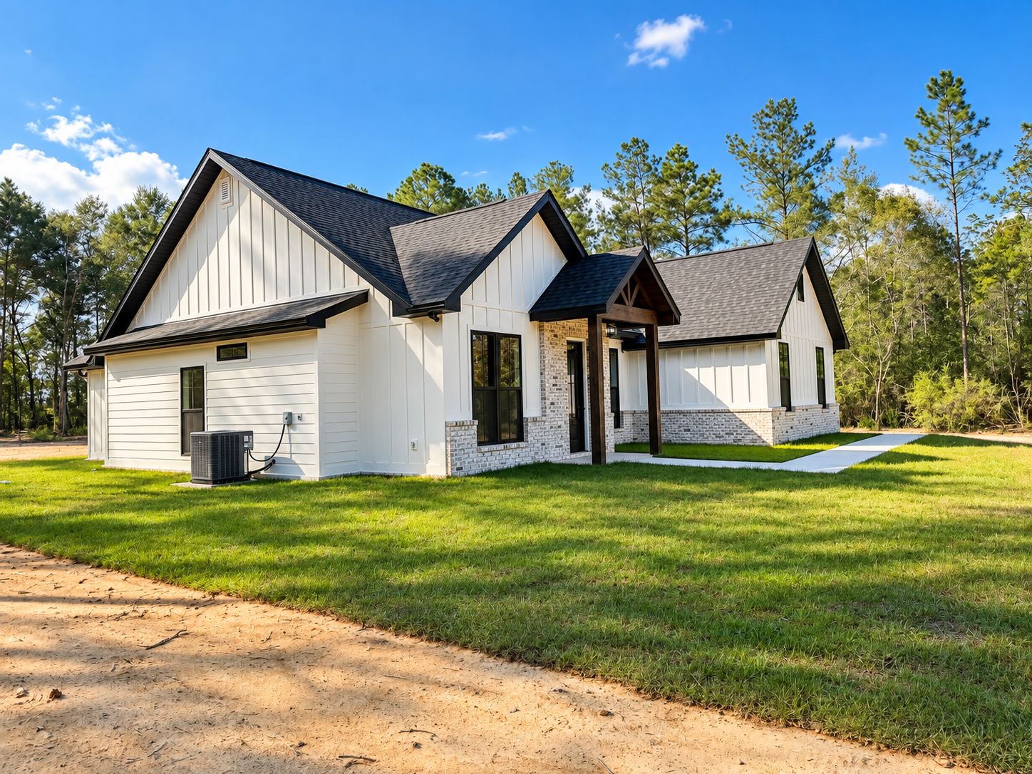 Angled exterior view of the white home with dark trim and a timber entry.