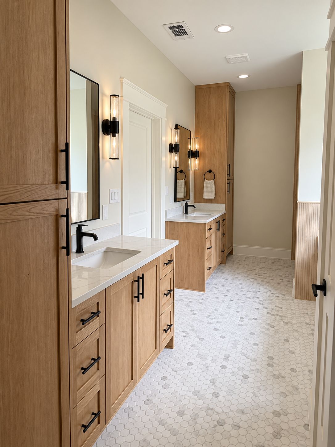 Bathroom with wood vanities, white countertops, black-framed mirrors, and patterned tile flooring.