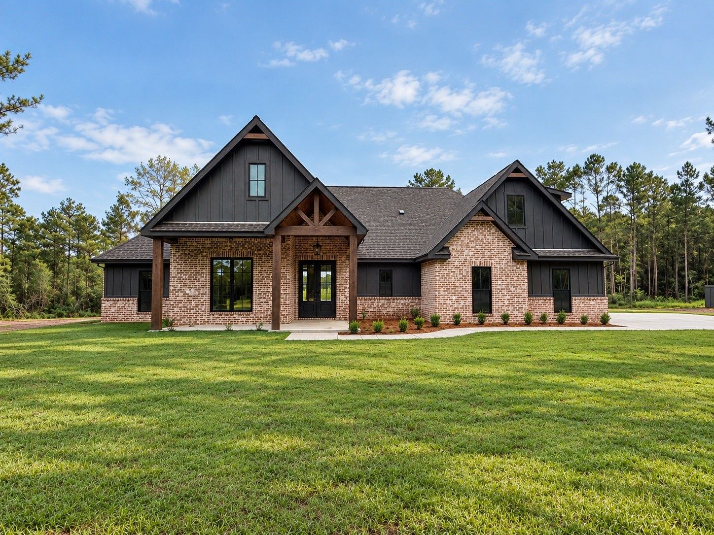 Single-story brick home with dark siding, twin front gables, and a covered entry.